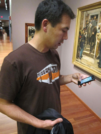 Man using mobile phone in gallery