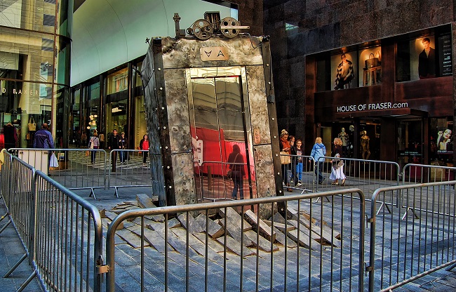 Photo of an artwork - a lift bursting through a pavement