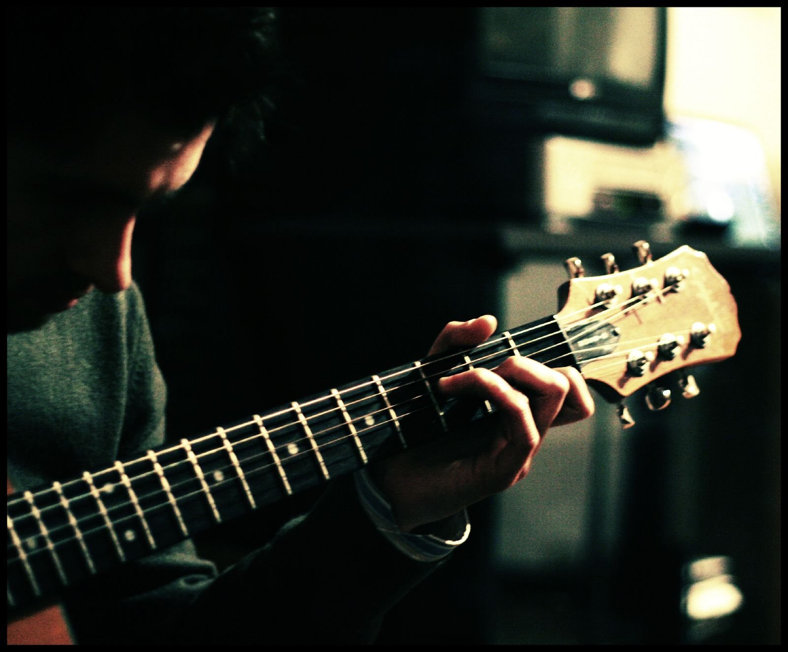 Photo of a man playing a guitar