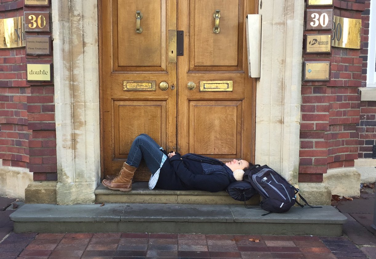 Photo of woman lying on a doorstep