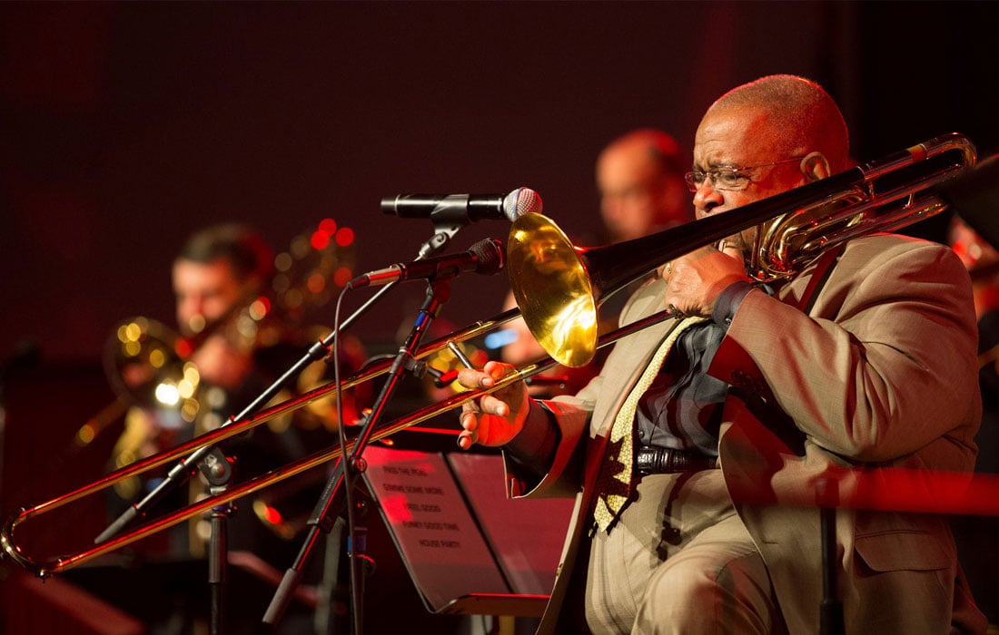 Man performing in orchestra's brass section