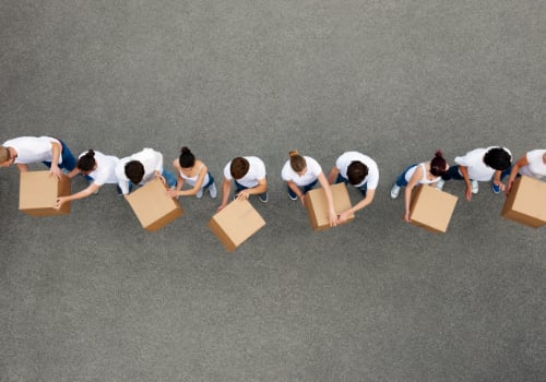 Birdseye view of people passing cardboard boxes