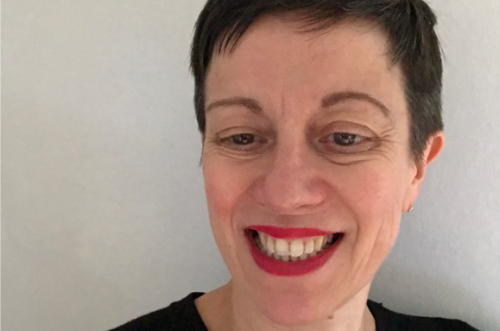 Anna Williams, Chief Operating Officer, Birmingham Royal Ballet. She is a white women with short brown hair. She is looking down and smiling. She wears red lipstick.