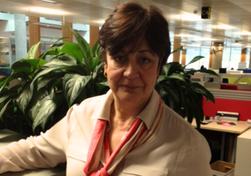 Susannah Simons stands in an office