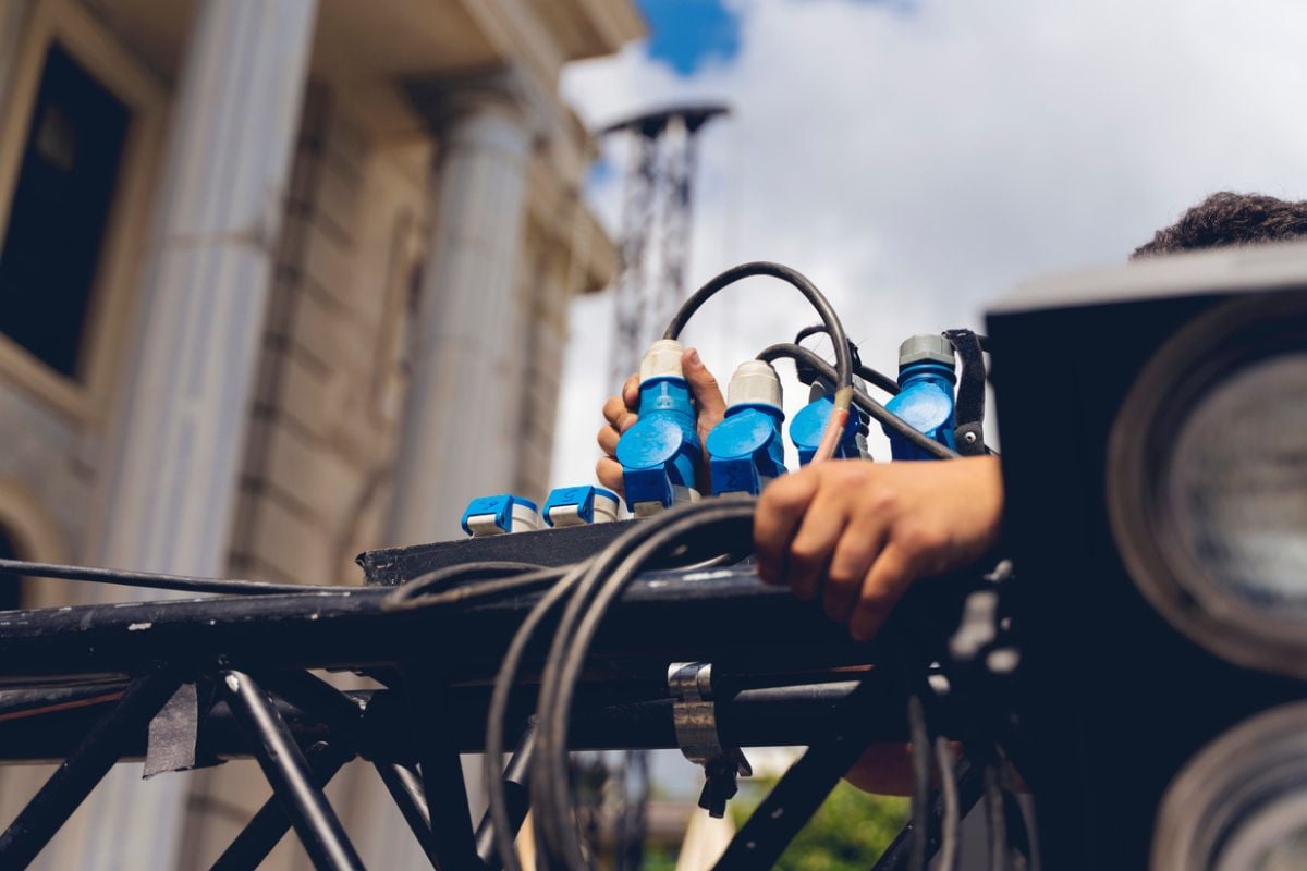 Technician plugs up lighting truss