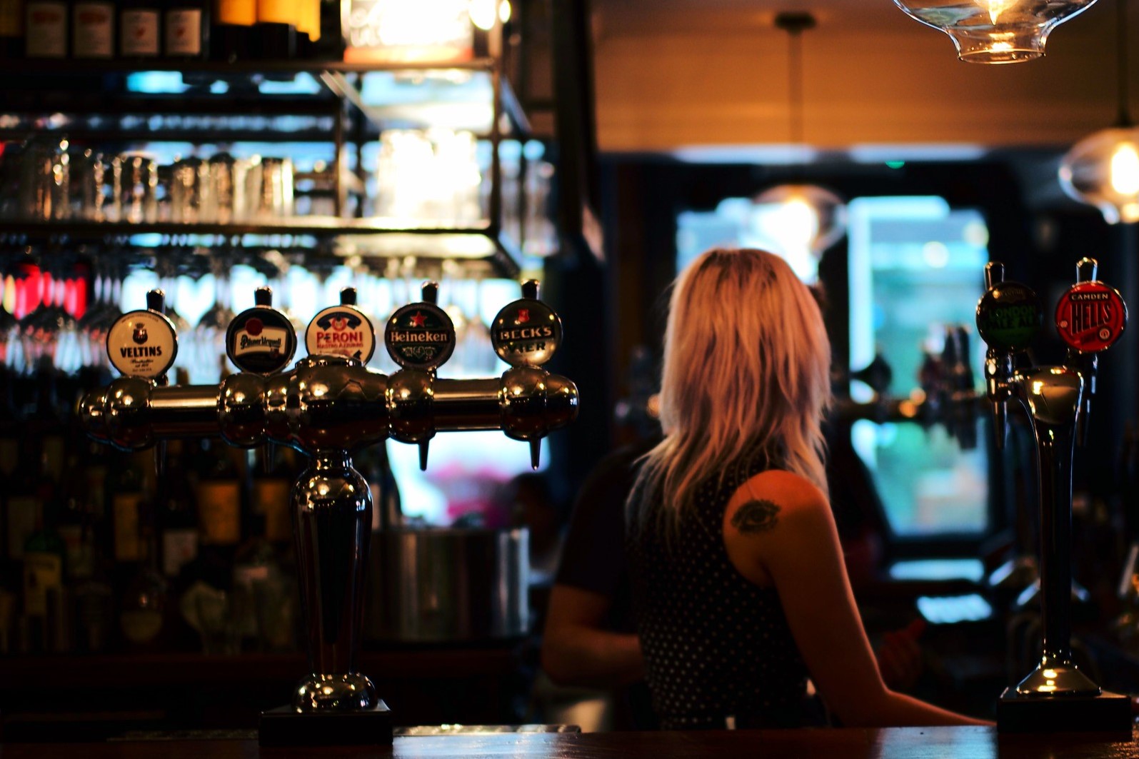 Woman in pub. Photo: Kamal Hamid/Creative Commons