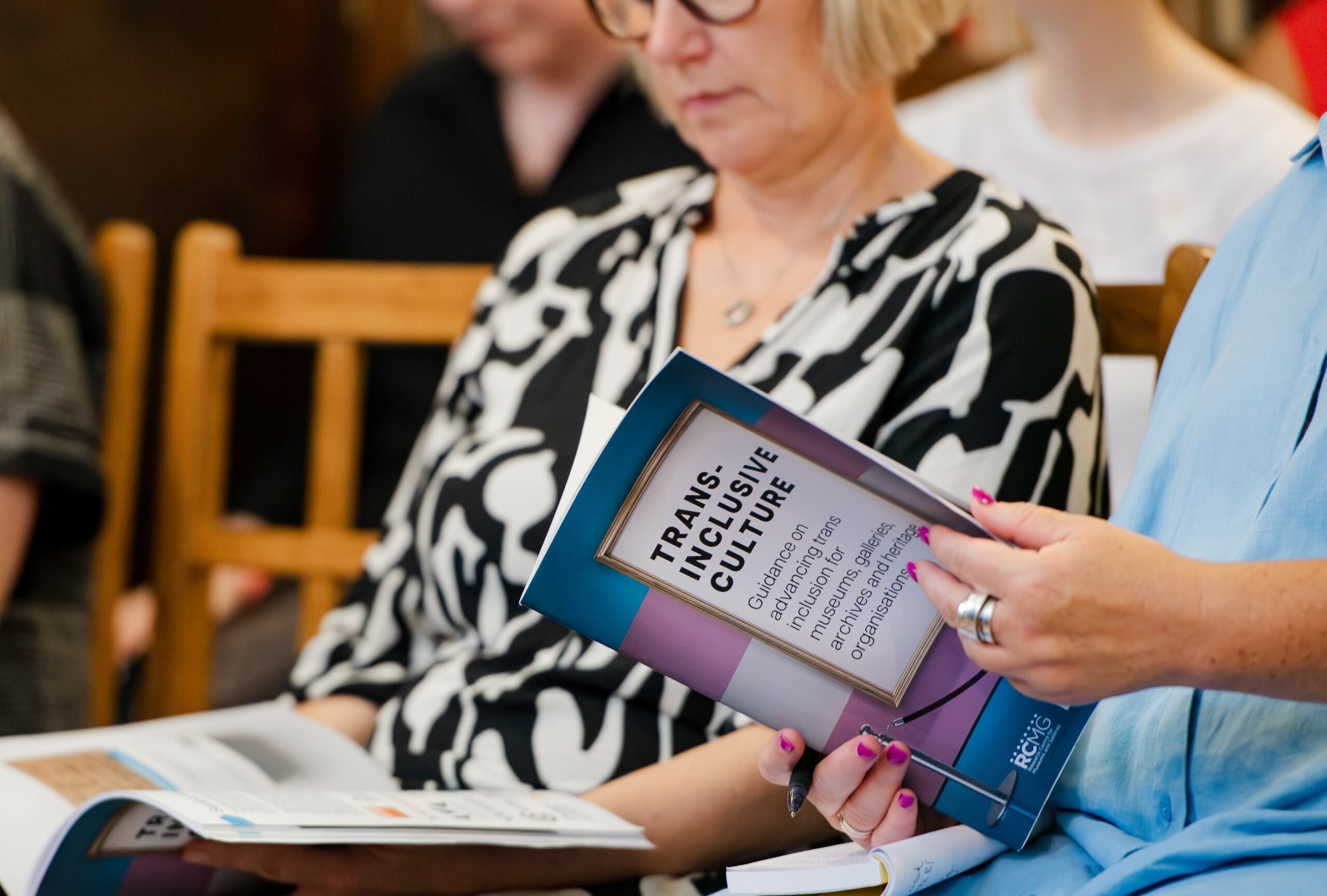 aunch attendees reading the trans inclusive guidance. Photos by Liz Isles