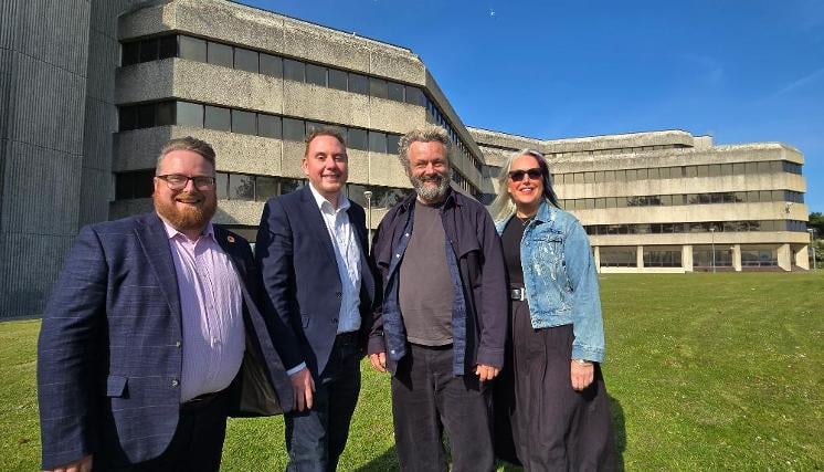 Michael Sheen (third left) in front of Swansea's civic centre, the new home for Welsh National Theatre