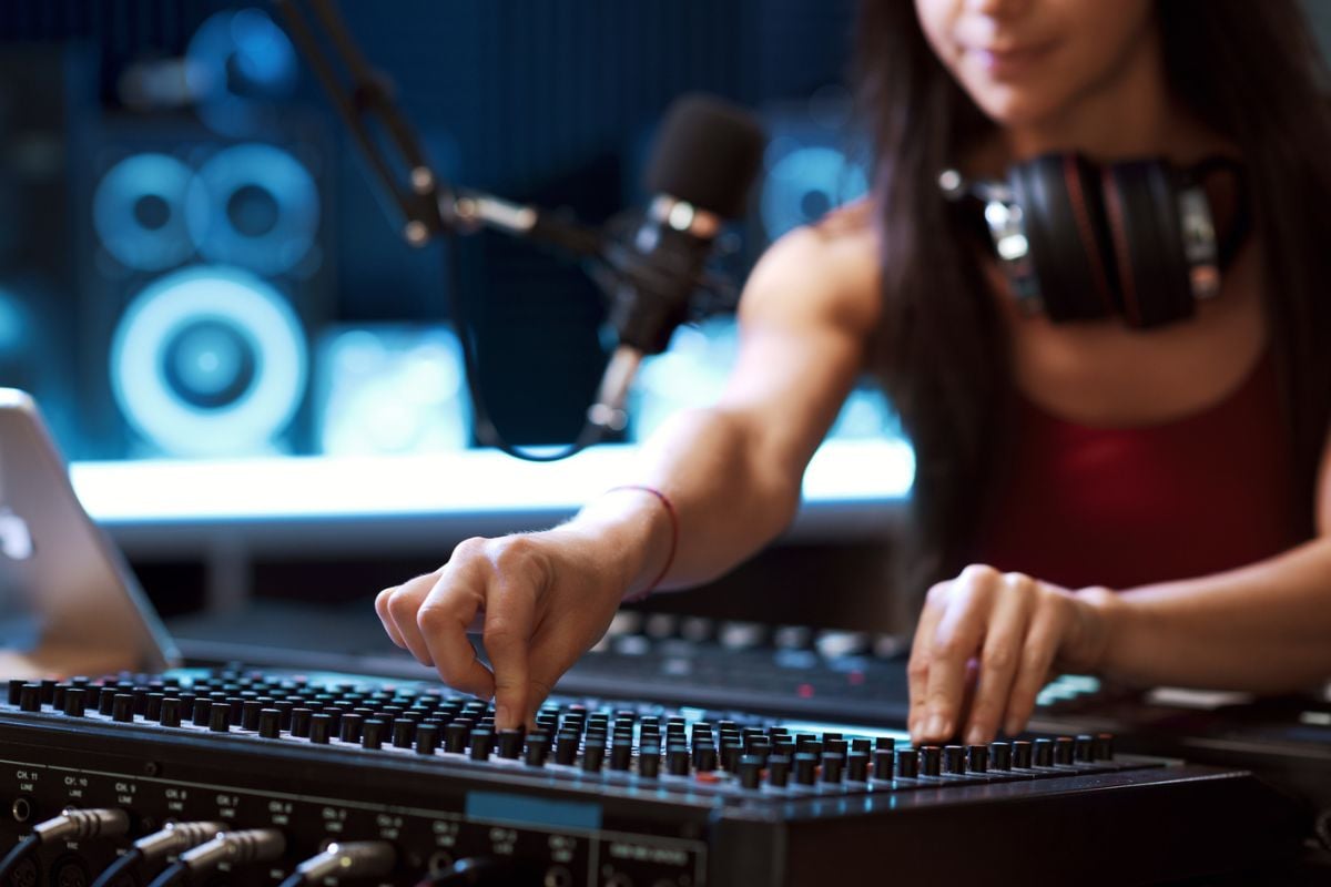 Female sound engineer at mixing desk