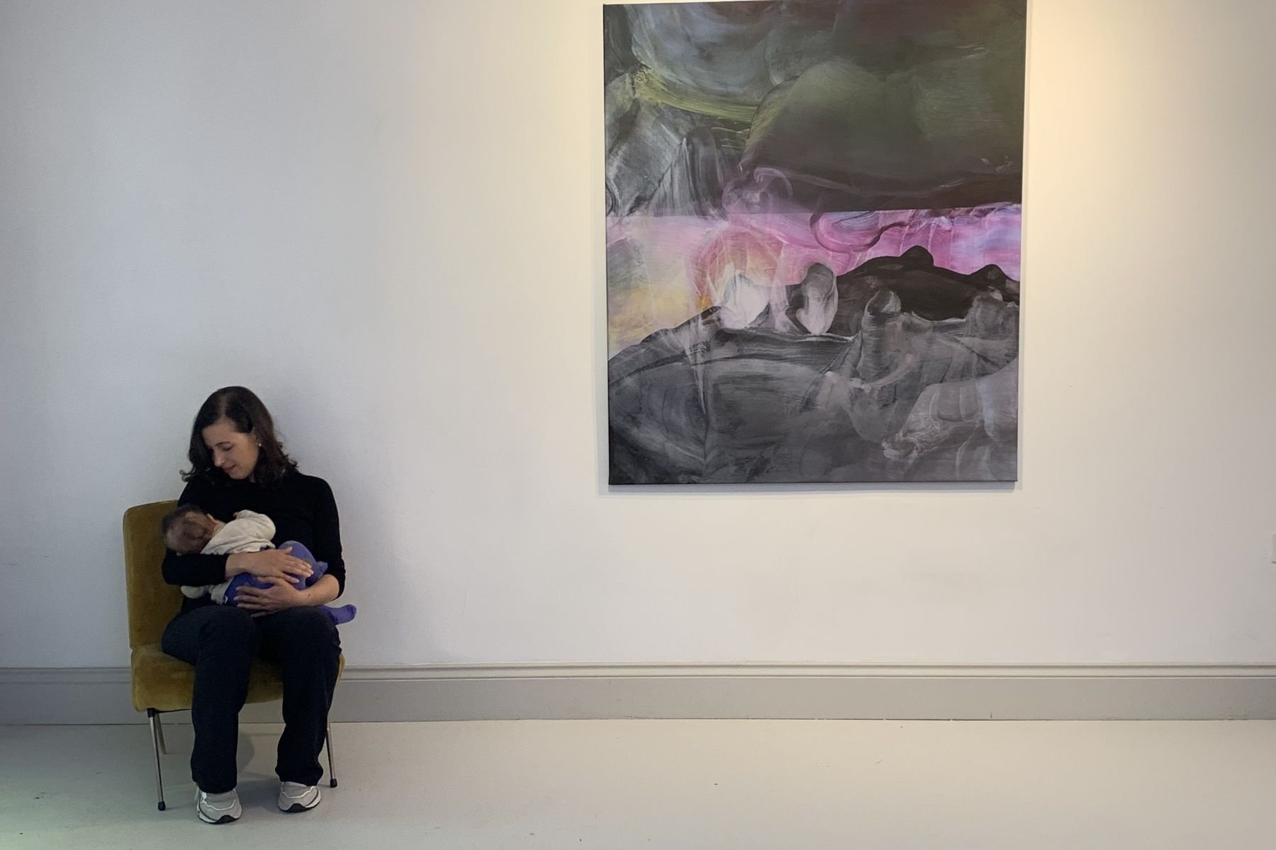 Woman breastfeeding in a gallery
