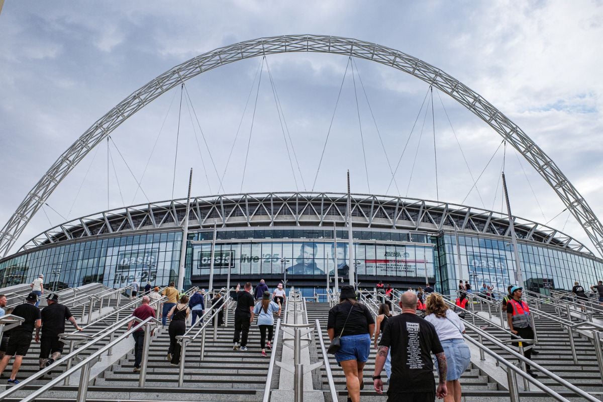 London, UK - 26 July, 2025: Oasis fans outside Wembley Stadium ahead of the Live 25 tour iStock
