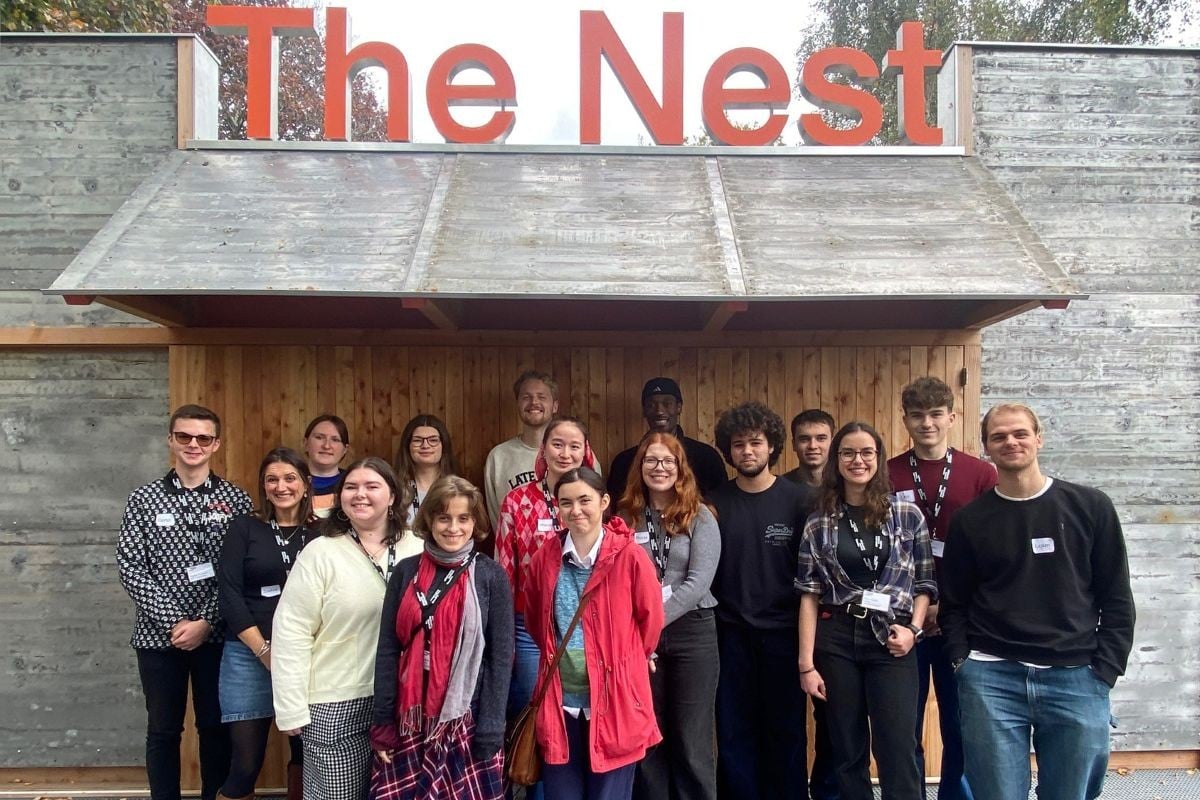 Chichester Festival theatre's youth advisory board stands in front of the sign to The Nest