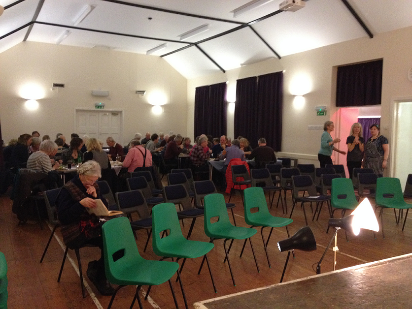 A typical rural touring scene: Village hall with a friendly buzz, early-arriving ticket holders are being fed while some bag the seat they want for the show well in advance, the local promoter, chef and committee member hover, on alert, by the door. This turned out to be a cracking night.