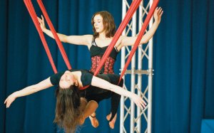 Two circus performers suspended in mid-air