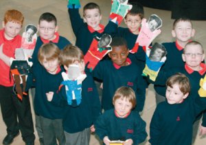 Children from Ewing School show off their puppet designs after a workshop at Manchester Art Gallery. Photo: Manchester City Galleries