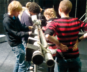 A group of children build a lighting rig