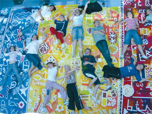 Children lay on a big brightly coloured banner