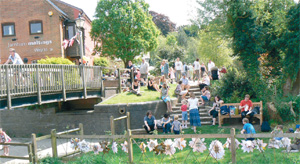 People gatheroutside Farnham Maltings on a summer's day