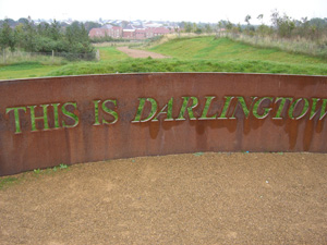 Metal wall with 'This is Darlington' cut into it