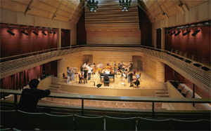 A group of musicians practise on stage