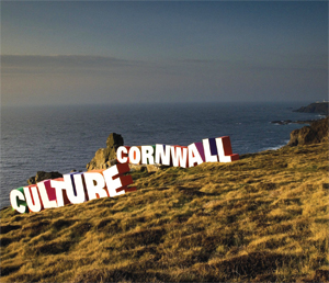 Sculptures of the words 'Culture' and 'Cornwall' sit on the grassy coast in Cornwall