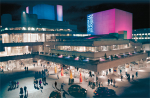 Night scene of the National theatre, lit with pink and blue lighting