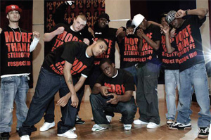 A group of young men aith baseball caps and T-shirts with ' more than a stereotype, reepect me', written on in big letters, pose for the camera.