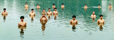 A group of men stand in the some water, withonly their upper torso and heads showing.