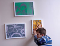 Young child handling a screenprint on a wall