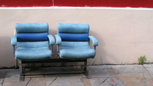 Two theatre-style seats in the middle of the street