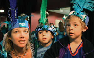 A lady and two children dressed in fancy handmade hats