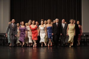 A row of dressed up over 65's on stage dancing