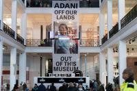 Protesters unfurl a 12-metre banner spanning the full height of the Science Museum's Energy Hall reading ‘Adani off our lands and out of this museum'