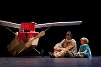 Photo of man and boy on stage with aeroplane