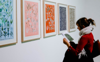 women looks at art in gallery