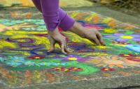 Photo of person doing chalk drawing
