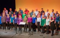A choir of people wearing colourful clothes