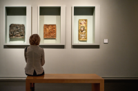 Woman looks at items in an exhibition