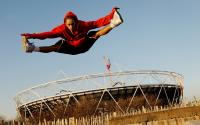 Photo of a dancer jumping in front of the Olympic stadium