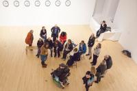 A group of people including a wheelchair user in an art gallery