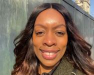 Eunice Obianagha, UK Music, Head of Diversity. She is a Black woman with brown hair and is photographed outdoors with the sunlight shining on her face.
