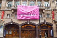 exterior of London Coliseum Theatre with pink banner reading #LoveENO
