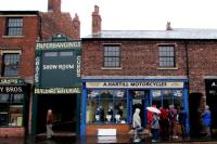 People outside a shop which is an exhibit at the Black Country Living Museum