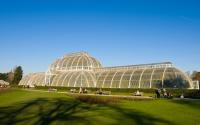 A photo of a large glasshouse and lawn
