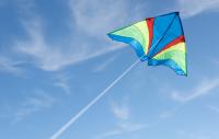 Photo of kite flying against blue sky