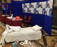 Photo of unmade bed on exhibition stand
