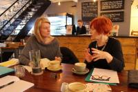 Photo of two women in conversation in a cafe
