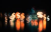 Image of multiple dollar signs in on a black background