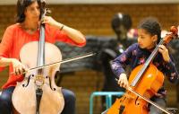 Photo of a tutor and pupil playing the cello