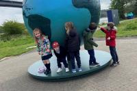 Children supporting a model globe